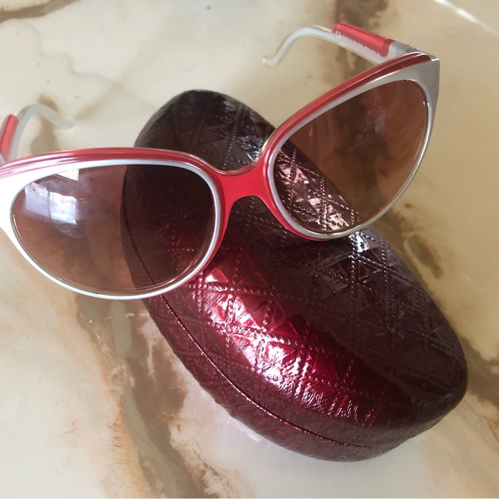 Corinne McCormick, burgundy and silver sunglasses with burgundy sunglasses case